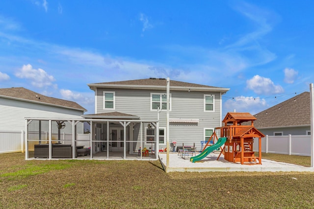 back of property with a playground, a patio, a lawn, a sunroom, and fence