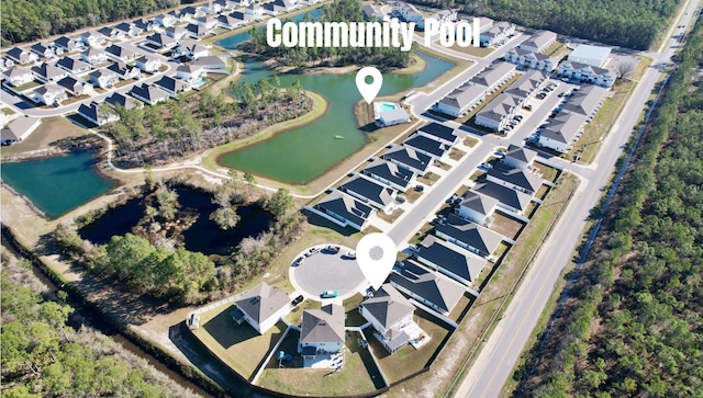 birds eye view of property featuring a water view and a residential view