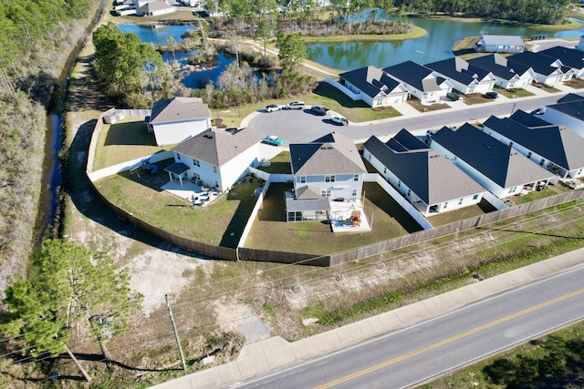 drone / aerial view with a water view and a residential view