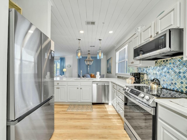 kitchen featuring stainless steel appliances, visible vents, backsplash, wood ceiling, and a sink