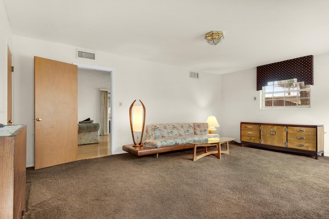 living area featuring carpet and visible vents