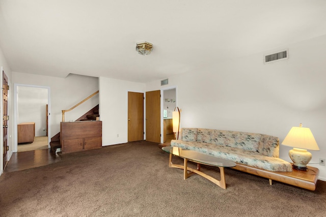 sitting room featuring stairway, carpet flooring, and visible vents