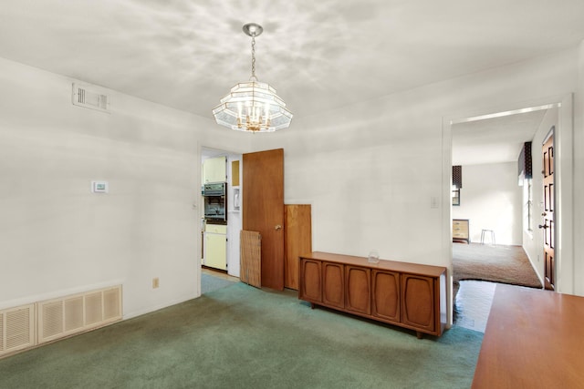 unfurnished dining area featuring visible vents, a notable chandelier, and carpet flooring