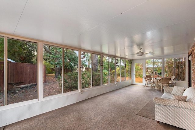 unfurnished sunroom with ceiling fan