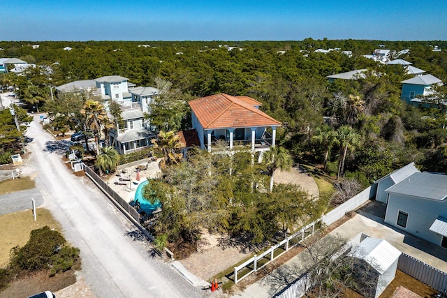 drone / aerial view featuring a wooded view