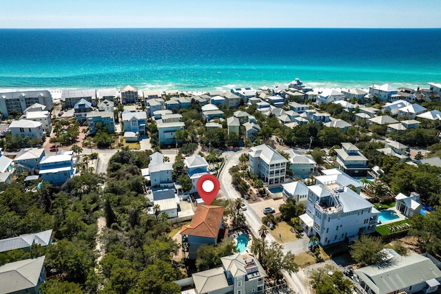 aerial view with a beach view, a water view, and a residential view