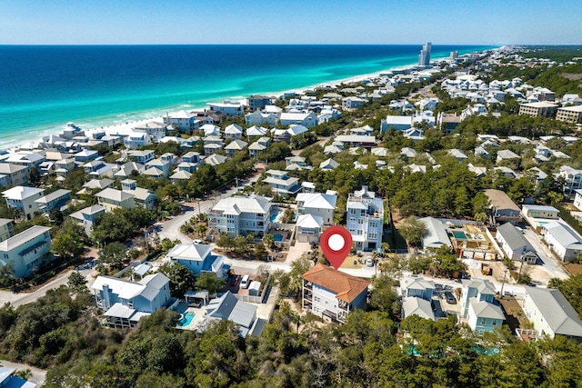 birds eye view of property featuring a water view, a residential view, and a view of the beach