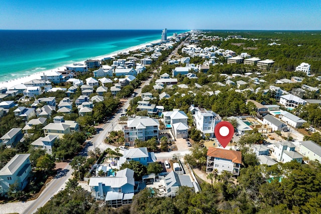 aerial view with a residential view, a water view, and a beach view