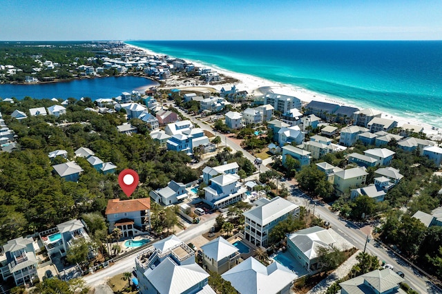 bird's eye view with a water view and a beach view