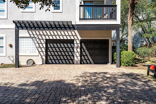 garage featuring decorative driveway