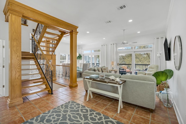 tiled living area with recessed lighting, visible vents, decorative columns, and stairway