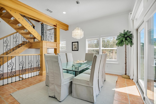 dining area with visible vents, an inviting chandelier, tile patterned flooring, baseboards, and stairs