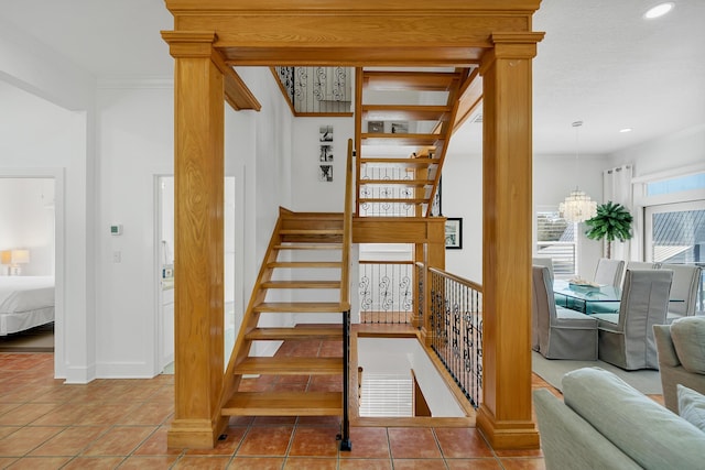 stairway with baseboards, tile patterned flooring, crown molding, a chandelier, and recessed lighting