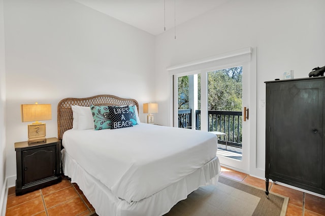 bedroom featuring access to exterior, baseboards, and light tile patterned flooring