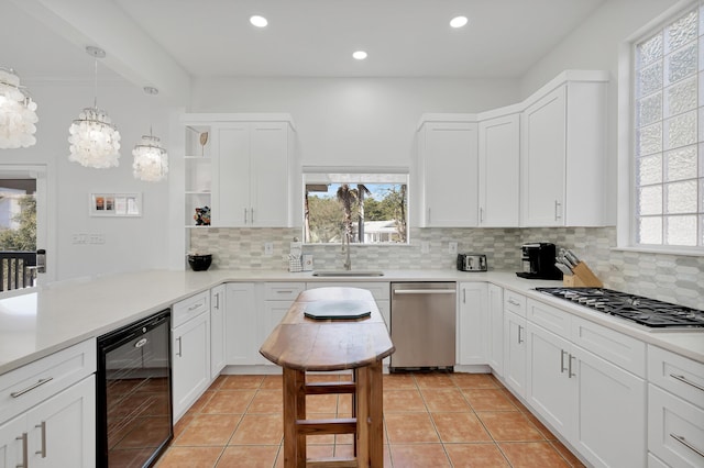 kitchen with gas cooktop, beverage cooler, a sink, stainless steel dishwasher, and open shelves