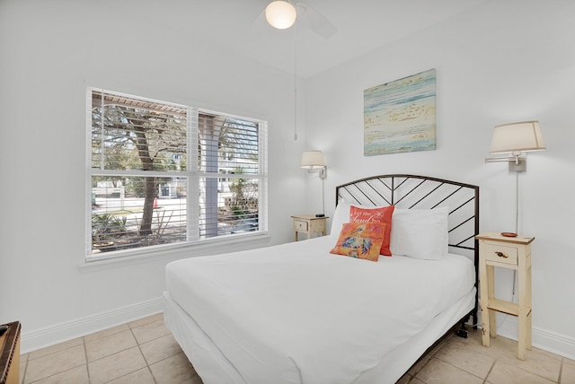 bedroom with light tile patterned floors, ceiling fan, multiple windows, and baseboards