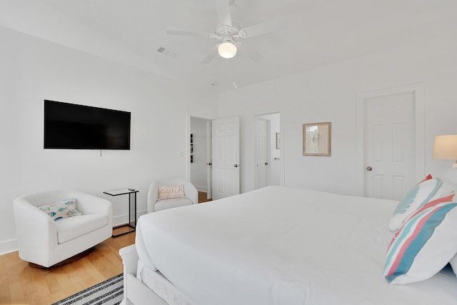 bedroom featuring visible vents, ceiling fan, and wood finished floors