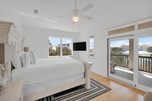 bedroom featuring access to exterior, visible vents, light wood-style floors, and ceiling fan