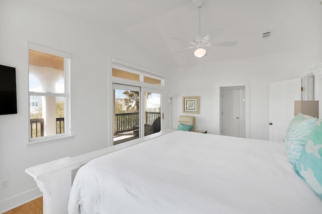 bedroom with wood finished floors, visible vents, a ceiling fan, vaulted ceiling, and access to outside