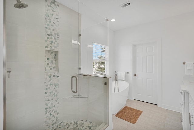 bathroom with visible vents, tile patterned flooring, a freestanding bath, vanity, and a shower stall