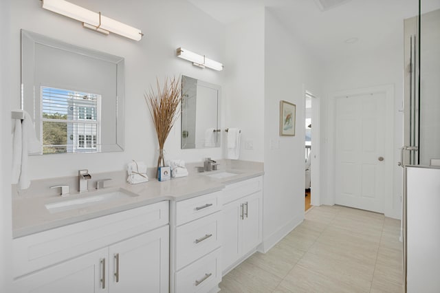 bathroom featuring tile patterned flooring, a sink, and double vanity