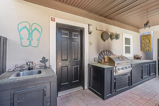 view of patio with a sink and area for grilling