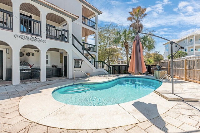 view of swimming pool with stairs, a patio, fence, and a fenced in pool