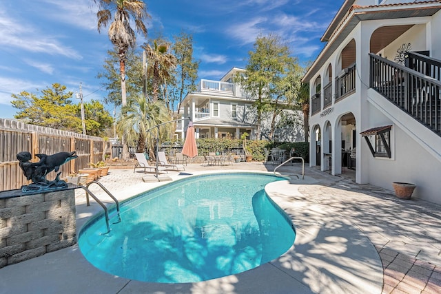 view of pool with fence, a fenced in pool, and a patio