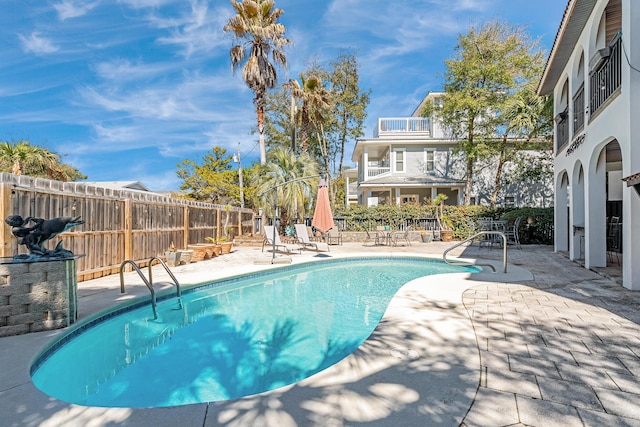 view of swimming pool with a patio, fence, and a fenced in pool