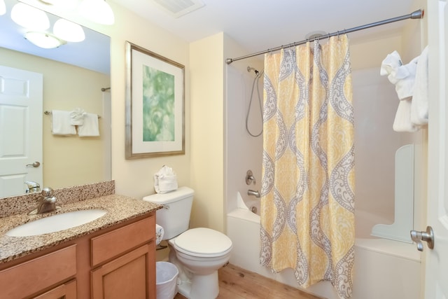 bathroom with toilet, shower / tub combo, wood finished floors, vanity, and visible vents