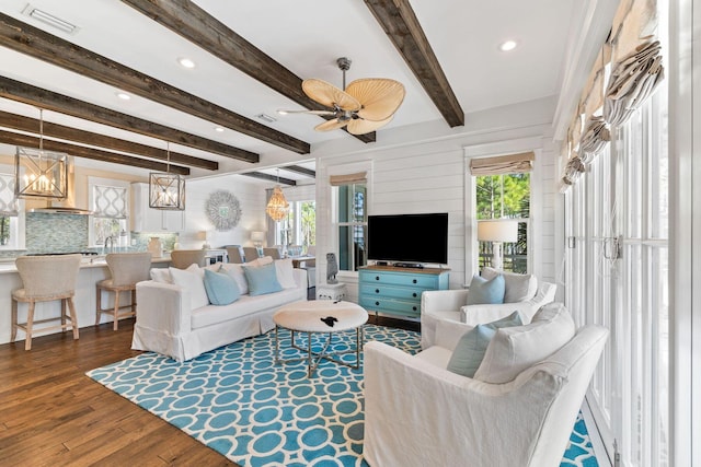 living room with recessed lighting, visible vents, wood finished floors, beamed ceiling, and ceiling fan with notable chandelier