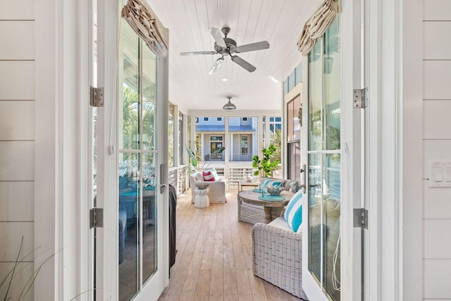 sunroom featuring a ceiling fan and french doors