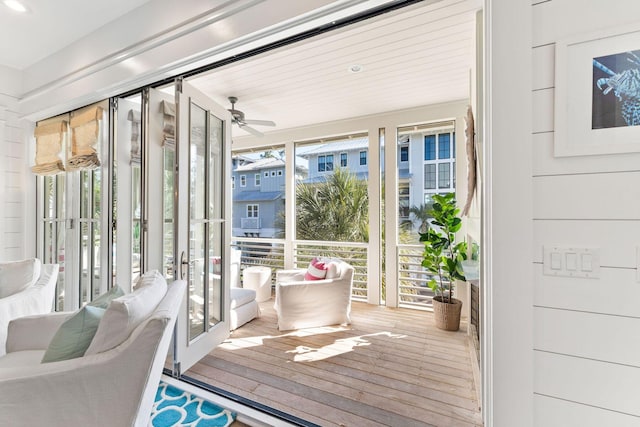 sunroom / solarium featuring a healthy amount of sunlight and ceiling fan