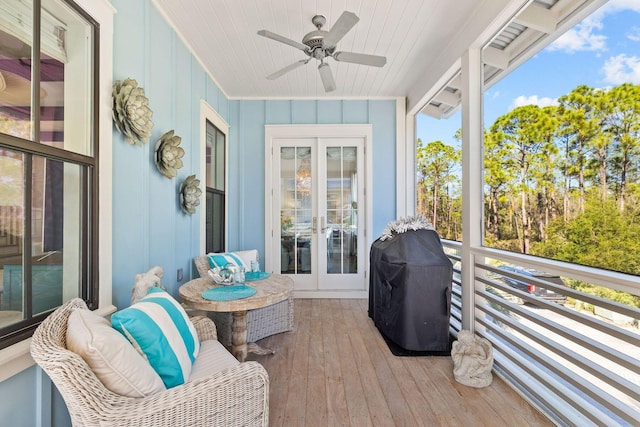 sunroom featuring wooden ceiling, ceiling fan, and french doors