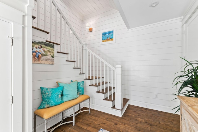 staircase with wood walls and hardwood / wood-style floors