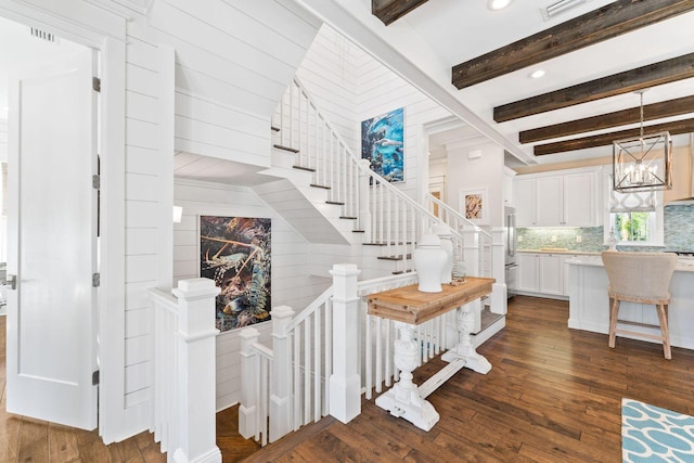 stairway featuring a chandelier, recessed lighting, beamed ceiling, and hardwood / wood-style floors