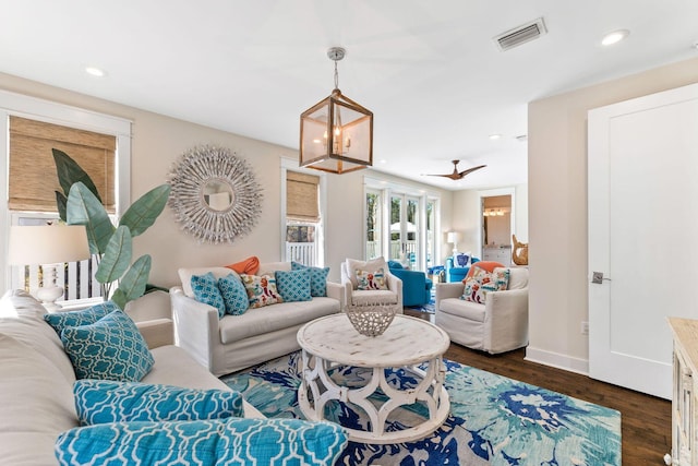 living room featuring dark wood-type flooring, recessed lighting, visible vents, and baseboards