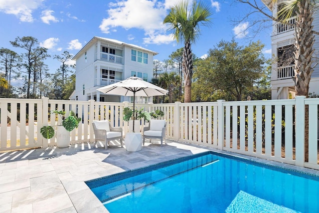 view of swimming pool with a fenced in pool and a patio