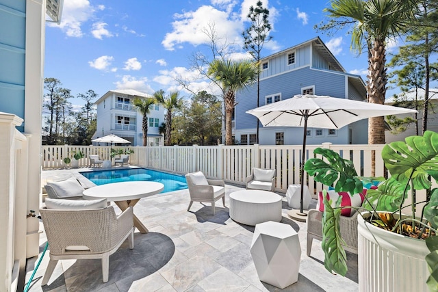 view of patio with fence, an outdoor living space, and a fenced in pool