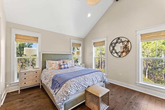 bedroom with multiple windows, baseboards, and dark wood finished floors