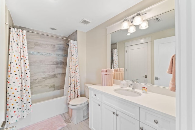 bathroom with toilet, shower / bath combo, visible vents, and vanity