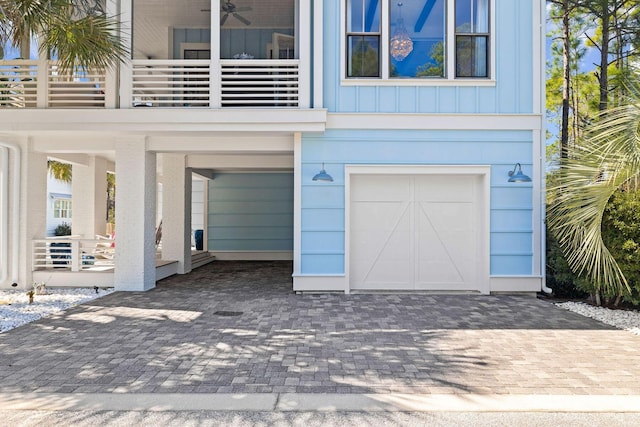 garage with decorative driveway