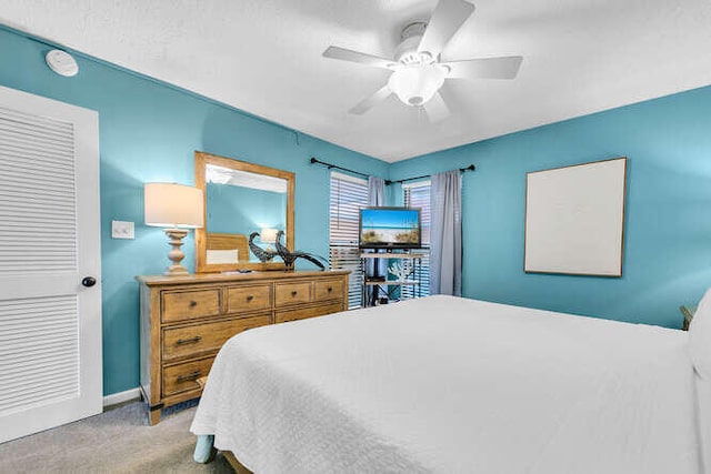 bedroom with carpet, a ceiling fan, and baseboards