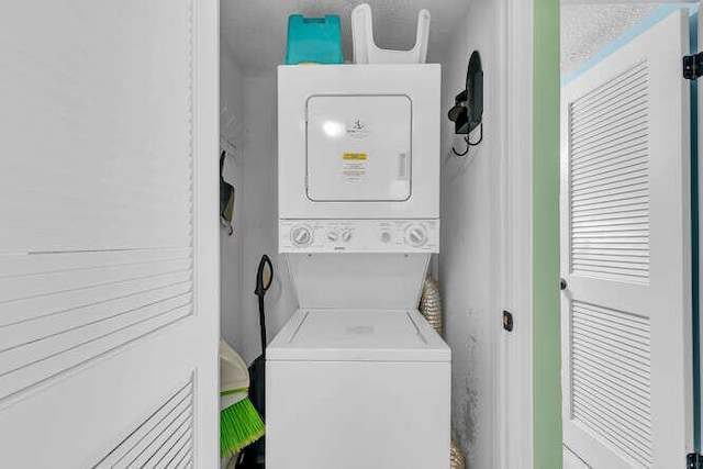 washroom with laundry area and stacked washer / dryer