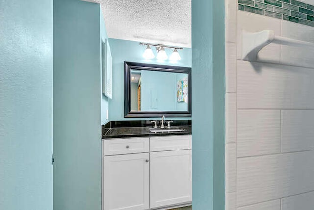 bathroom with a textured ceiling and vanity