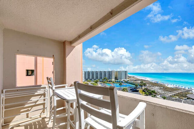 balcony with a beach view and a water view