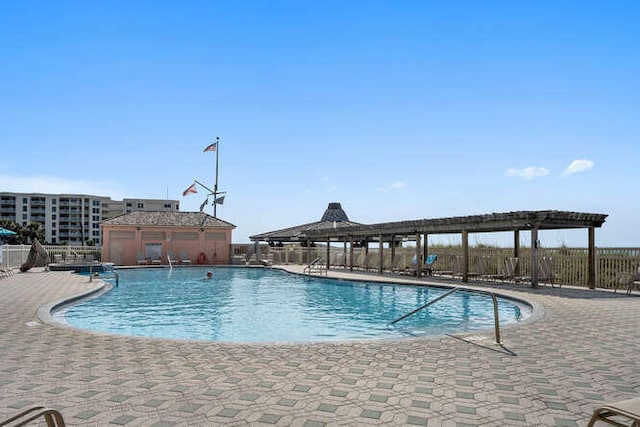 pool featuring a patio area and fence