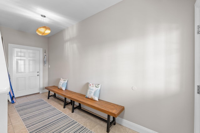 interior space with light tile patterned floors and baseboards