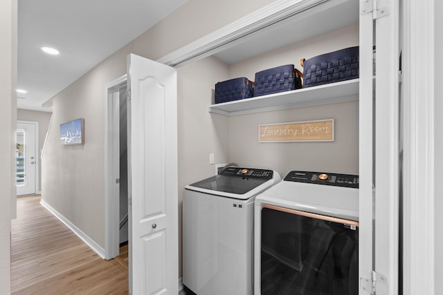 laundry area with light wood finished floors, recessed lighting, washing machine and dryer, laundry area, and baseboards