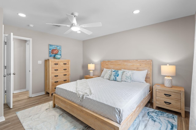 bedroom featuring baseboards, light wood-type flooring, a ceiling fan, and recessed lighting